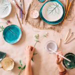 potter woman paints ceramic cup. Woman working In her pottery studio | ASD Market Week