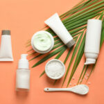Different skin care cosmetic products with green leaf on color b | ASD Market Week