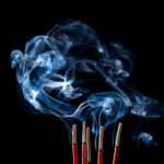 Smoking incense sticks on black background | ASD Market Week
