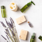 Flat lay of self-care routines on neutral tones background. Natural cosmetic products with lavender flowers and essential oils for Healthy lifestyle. Top view | ASD Market Week