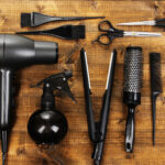 Hairdressing tools on wooden table close-up | ASD Market Week
